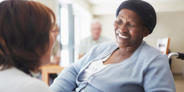 Senior woman smiling with her caregiver
