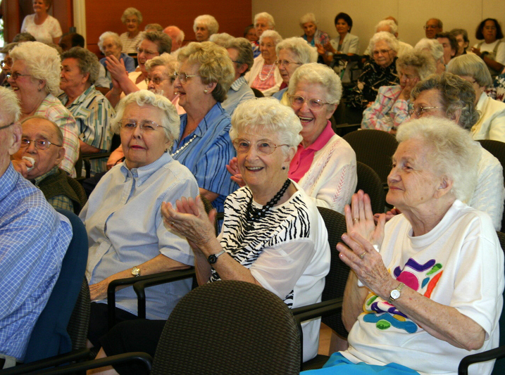 A group of seniors at church, singing and having fun