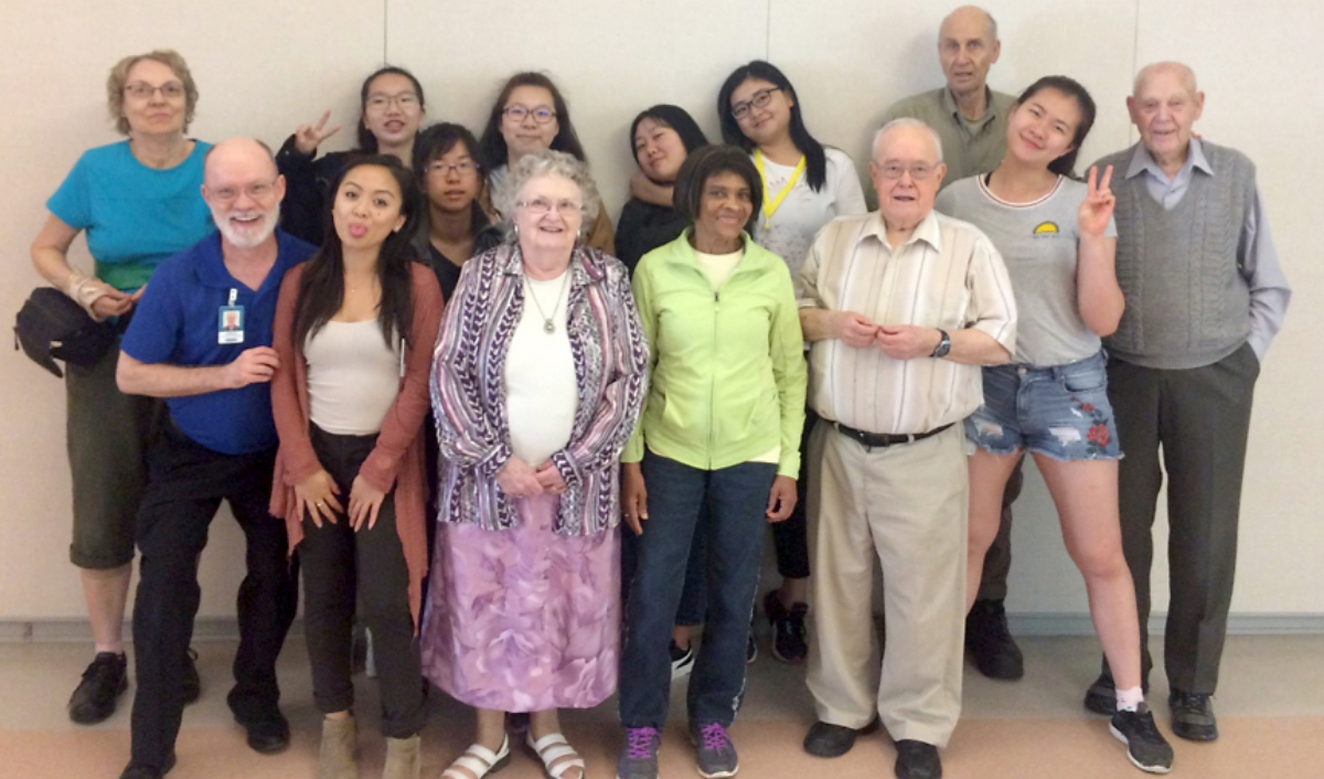 Group photo of young and senior volunteers and staff