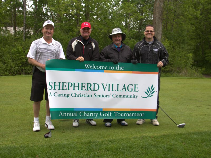 Group photo with Shepherd Village banner