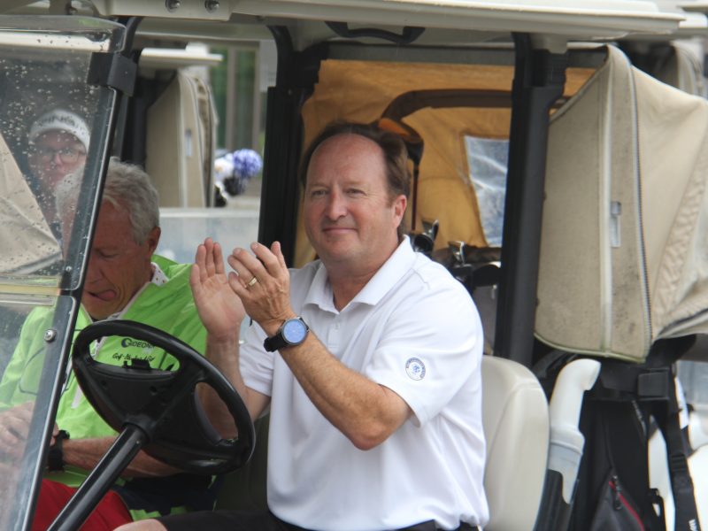 Golfer in golf cart clapping