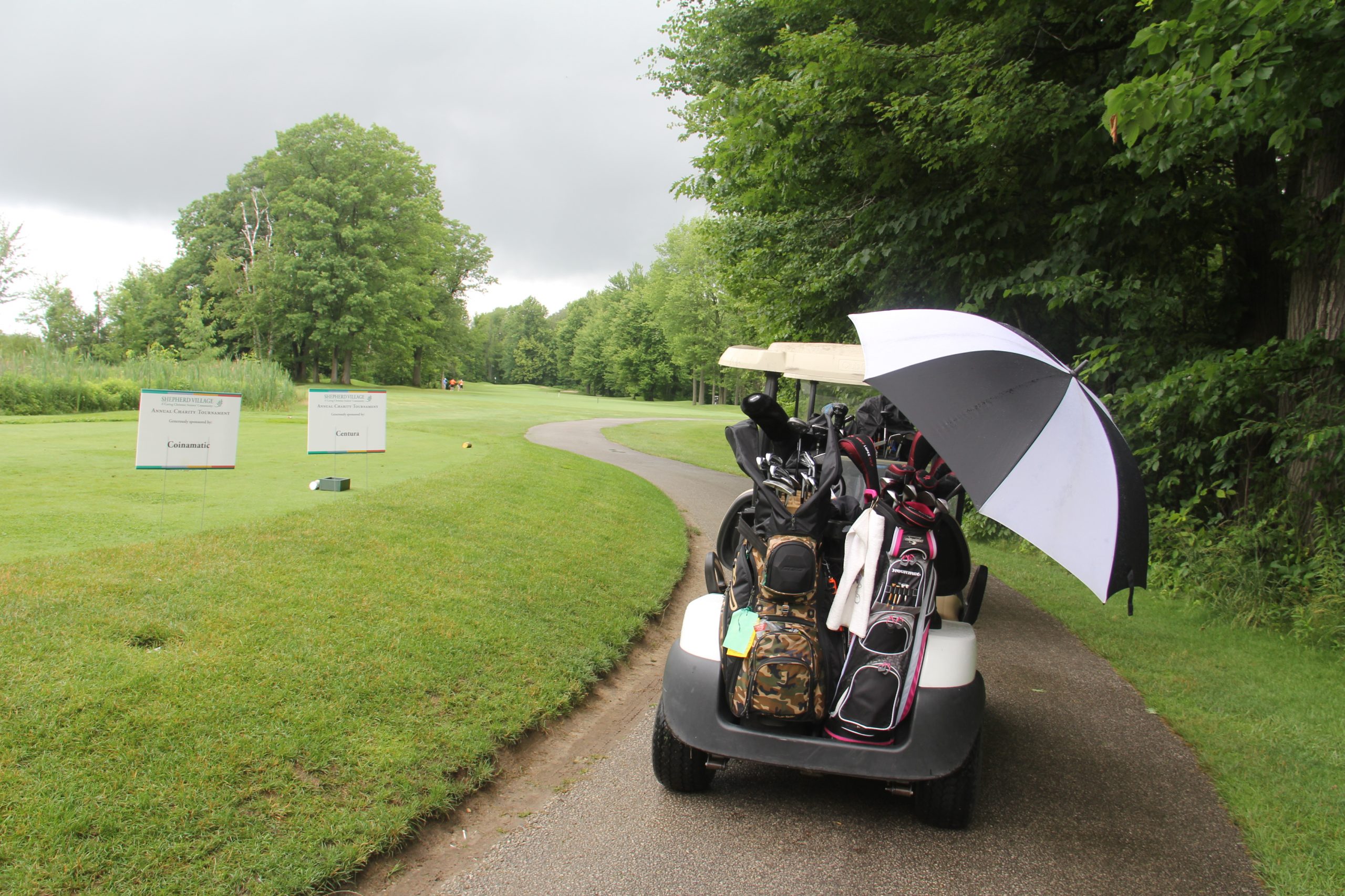 Golf cart driving across a golf course.